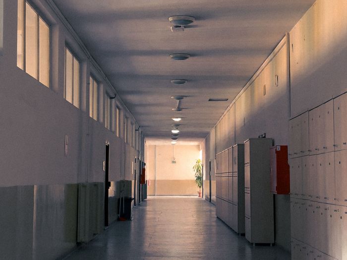 An empty school hallway lined with lockers